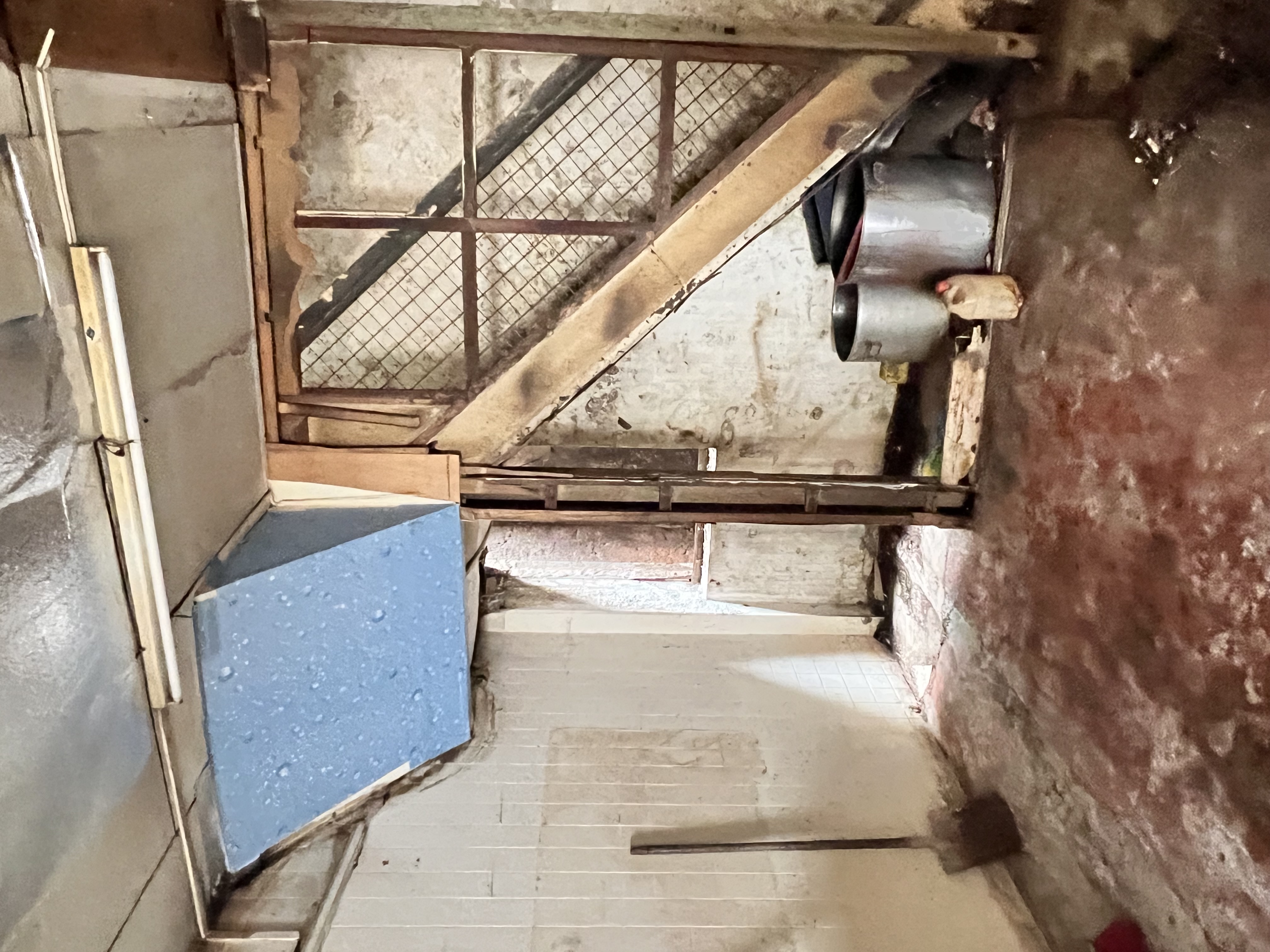 Looking outward from the dim interior — signs of decay and graffiti.