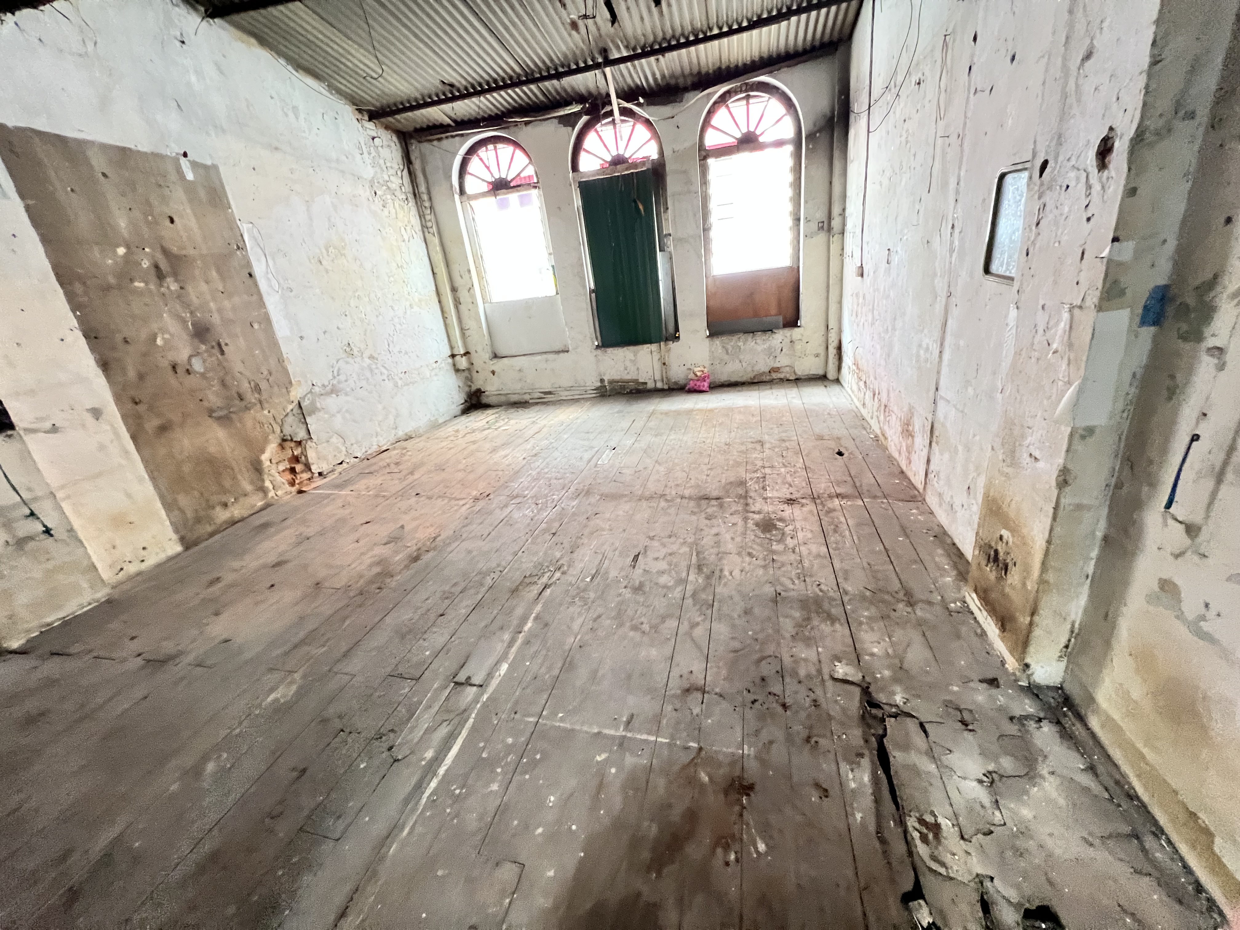 The timber platform upstairs — weakened and dangerous to walk on.