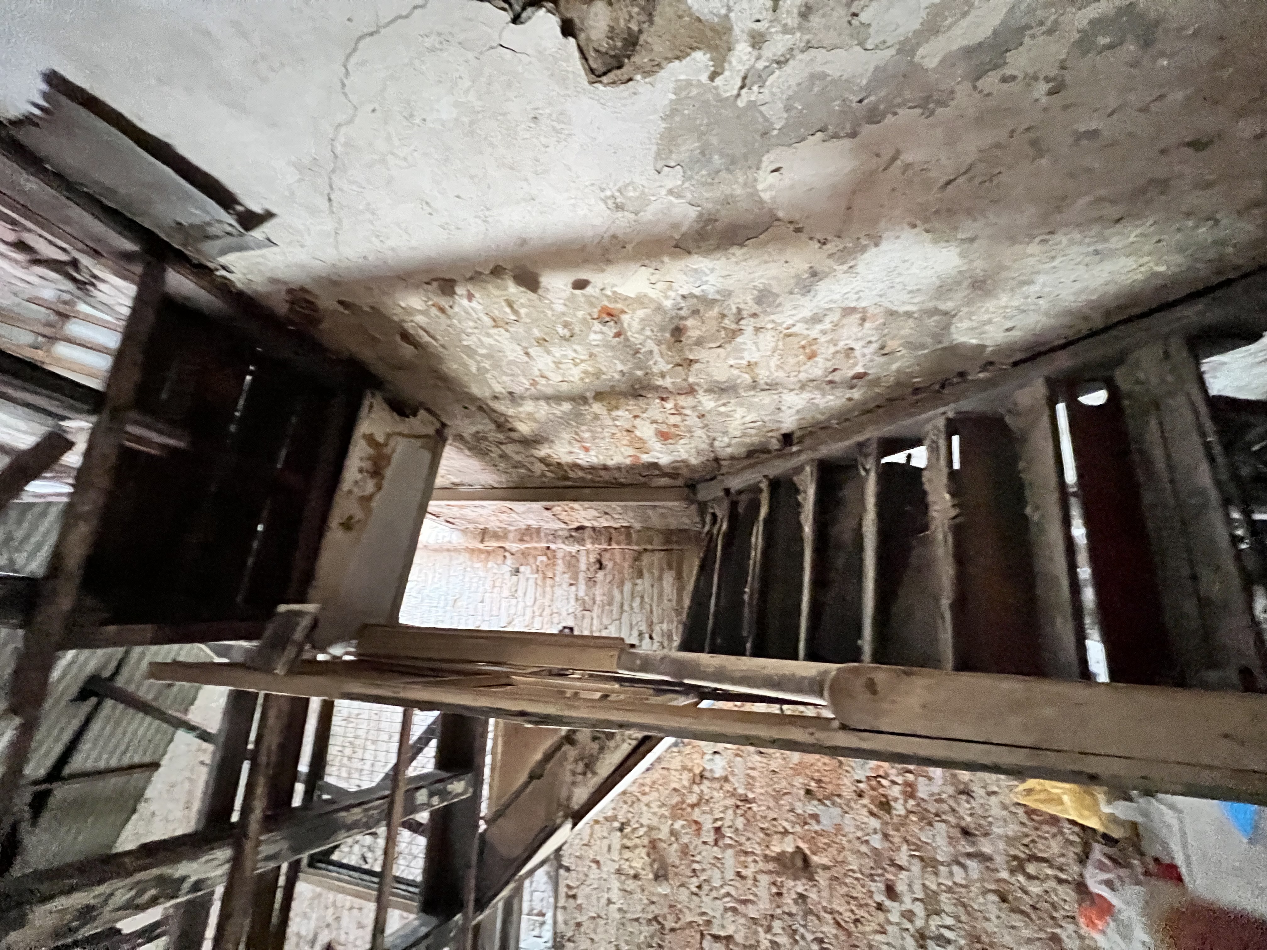 The original staircase — aged, unstable, and missing steps.